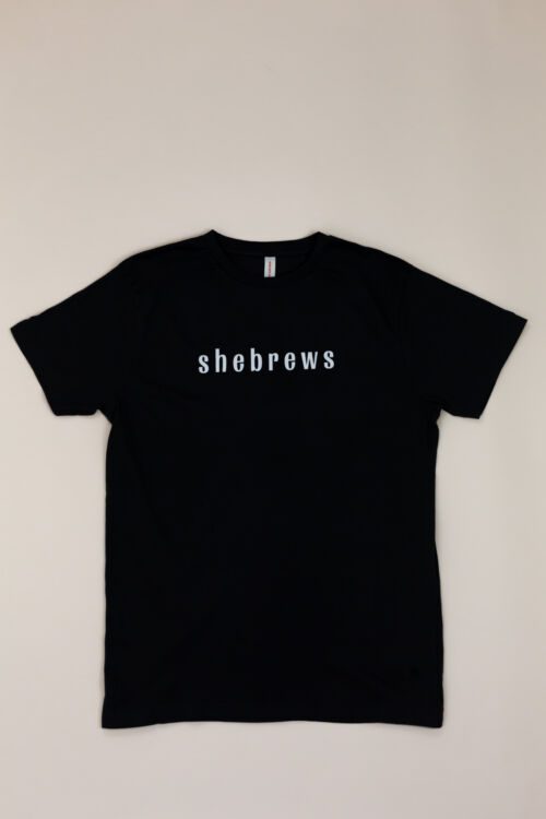 Front of black She Brews t-shirt with bold “shebrews” lettering