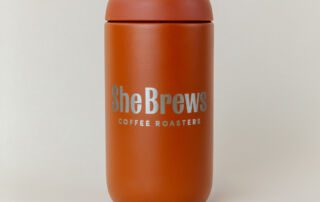 she-brews-coffee-canister-Sienna-unsung-roasters. Sienna She Brews Coffee Roasters airtight canister with bold branding