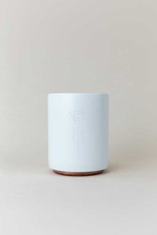 Back of white ceramic She Brews mug featuring Truly Transformative Coffee logo and cork base