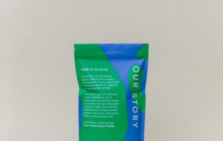 she-brews-sheland-blend-back-12oz-unsung-roasters. Back of She Brews Sheland Blend 12oz coffee bag showing brand story and mission