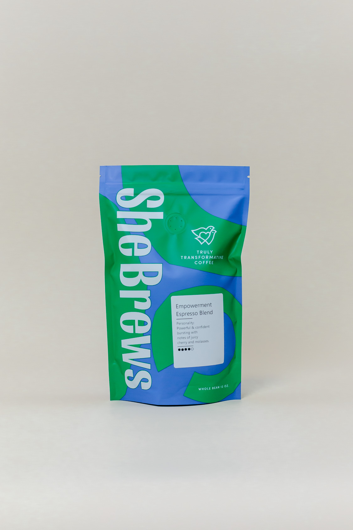 Front of She Brews Sheland Blend 12oz coffee bag in blue and green packaging