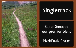 rocky-mountain-roastery-singletrack-premier-blend-label-unsung-roasters Singletrack coffee label featuring a winding mountain trail and roast details.